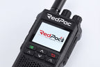 A close-up of a RedPoc handheld radio device with its screen on, displaying the RedPoc logo. The device is black with a textured grip, side knobs, and control buttons on a clean white background.